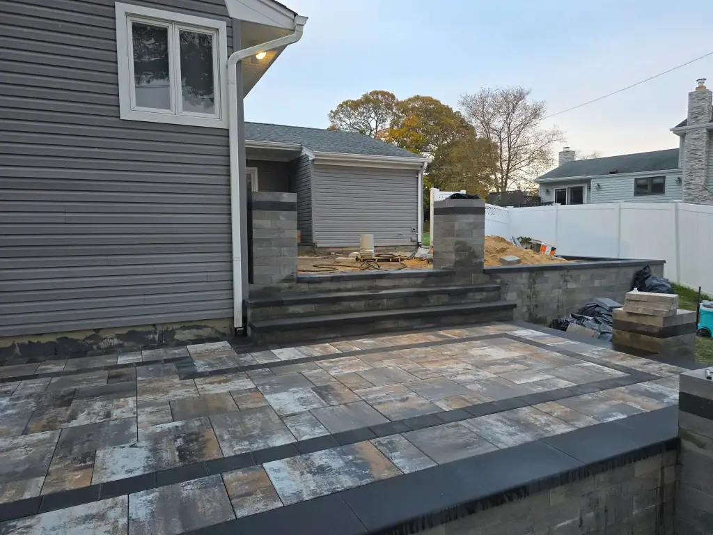 Backyard patio construction in Suffolk County, New York creating a durable outdoor space for relaxing, dining, and entertaining